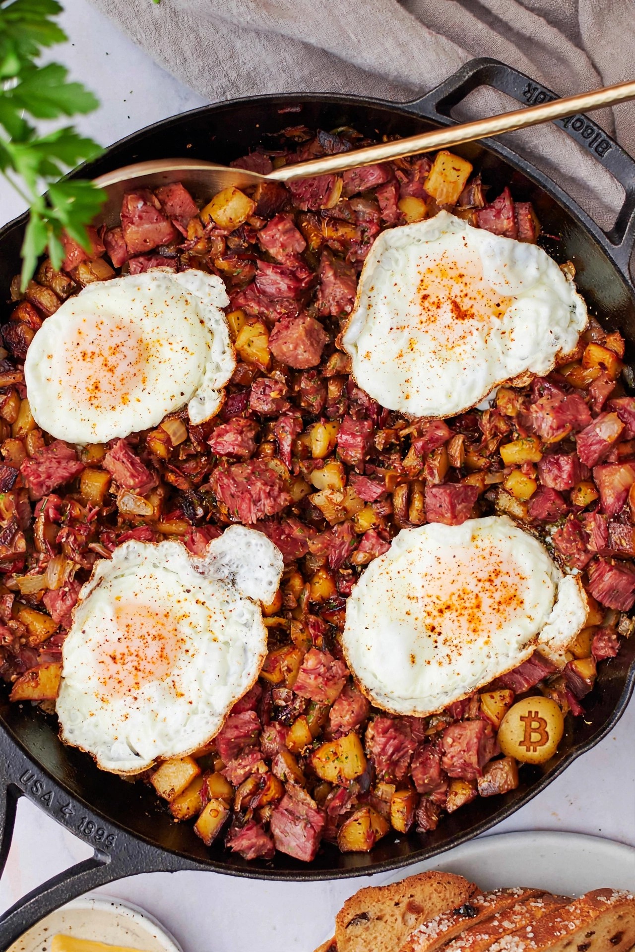 Crispy corned beef hash with diced potatoes and onion, topped with a fried egg